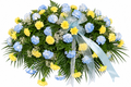 Sunlit Serenity Tribute with blue and yellow carnations